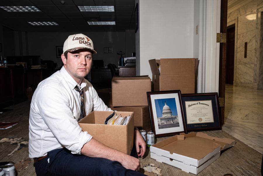 A staffer packing a congressional office into boxes at night